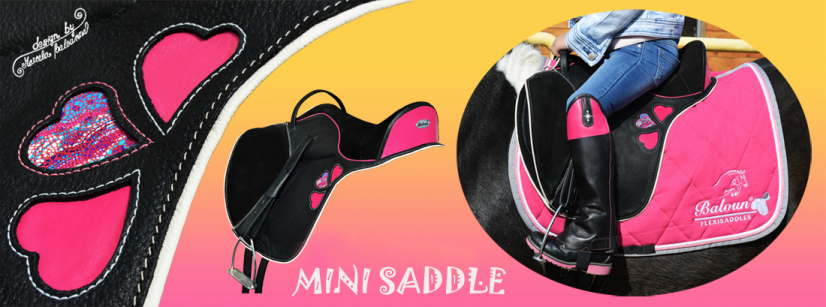 Black mini saddle Baloun for children with pink hearts on both sides, pink paspel and back cantle.